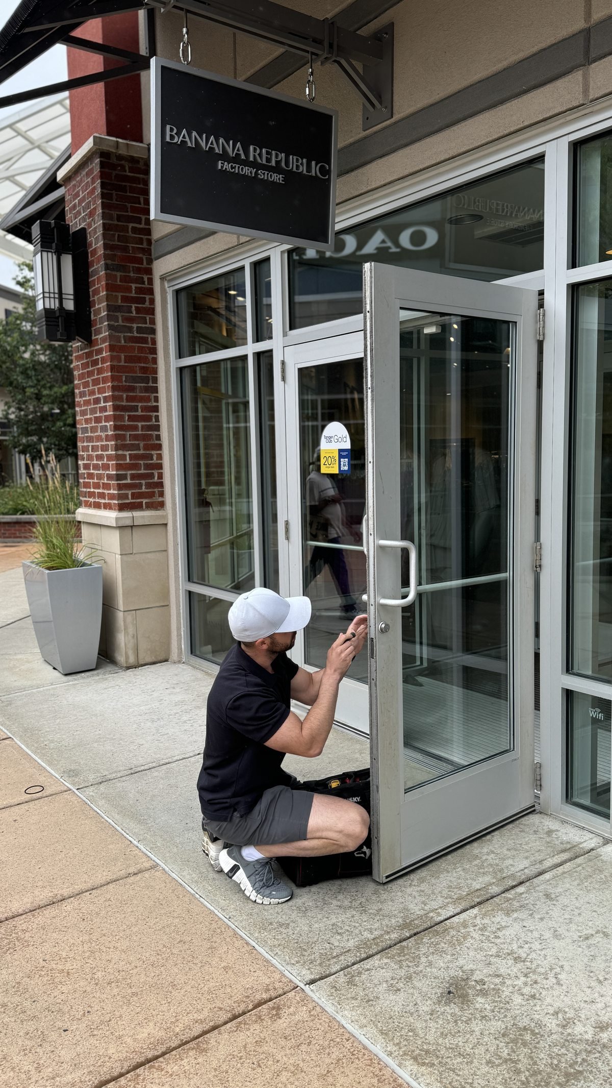 Locksmith Powell Ohio owner working on a commercial storefront door lock — mobile locksmith serving Powell Delaware Sunbury and Lewis Center Ohio