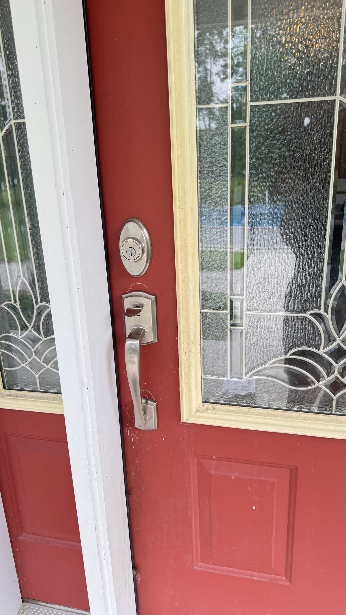 New satin nickel deadbolt and handleset installed on red residential front door by Locksmith Powell Ohio in Delaware County
