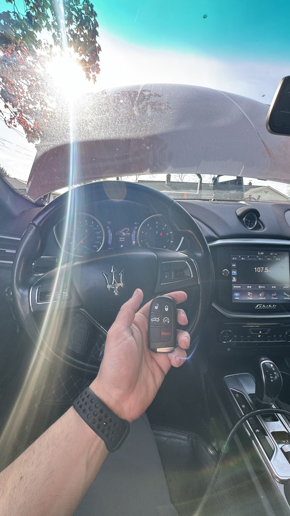 Locksmith Powell Ohio programming a Maserati Ghibli key fob inside vehicle cabin — luxury car key service in Powell Ohio